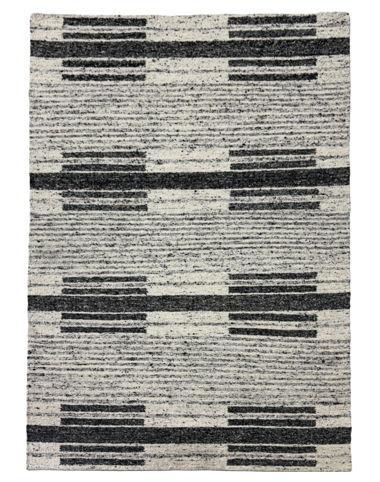 A modern striped carpet in charcoal and ivory, featuring a flat weave with a wool and cotton blend, perfect for contemporary interiors.