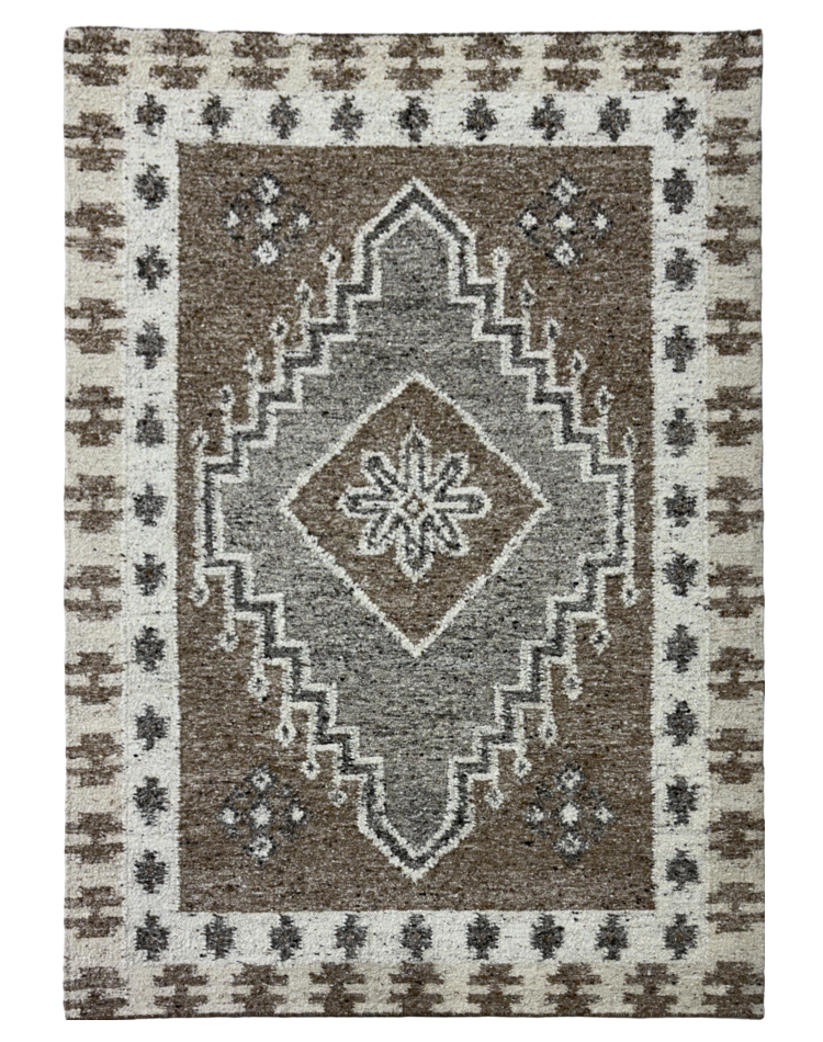 A transitional flat weave carpet with a medallion design in gray and beige tones, crafted from a wool and cotton blend.