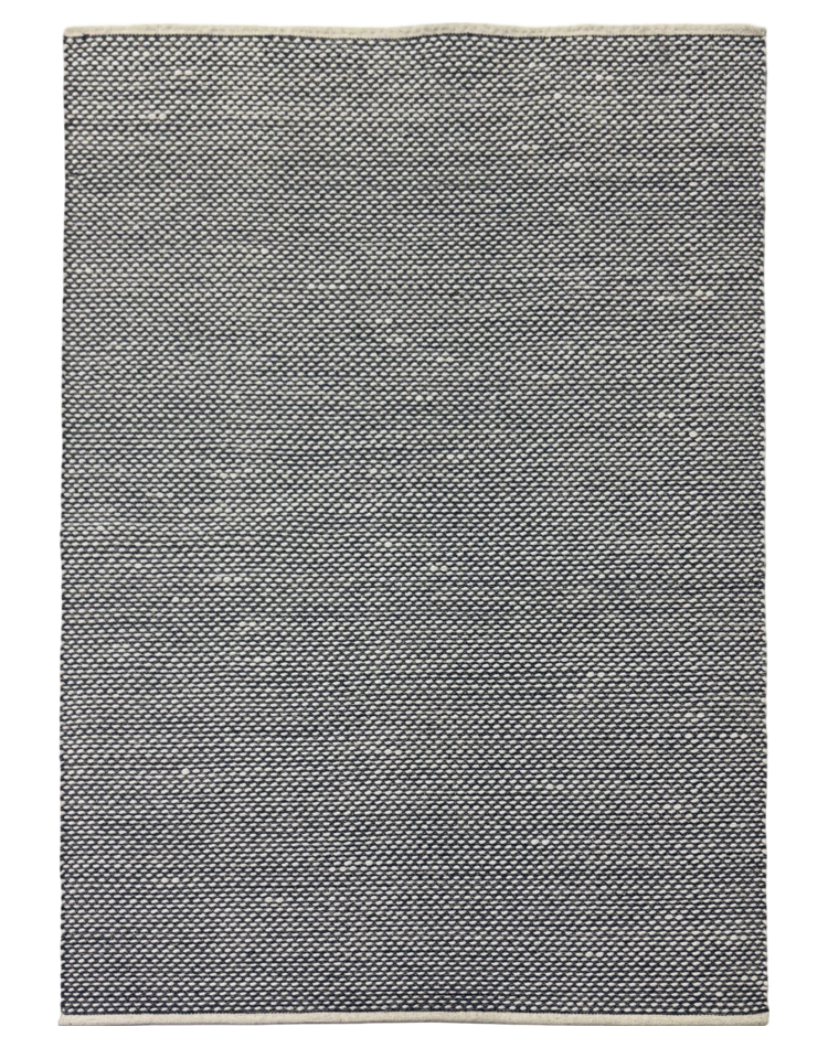 A modern flat weave wool carpet in navy blue with a textured solid pattern, perfect for contemporary spaces.