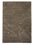 A modern brown wool carpet with a textured solid pattern displayed on a marble floor.