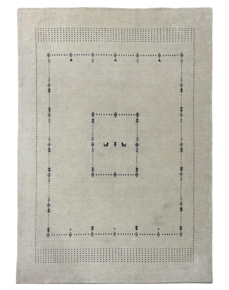 Beige loom-knotted rug with a geometric pattern and charcoal accents, ideal for elegant home interiors.