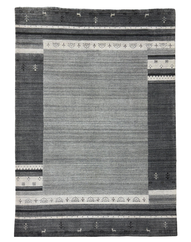 Elegant loom-knotted carpet in grey with textured solid pattern, perfect for modern transitional spaces.